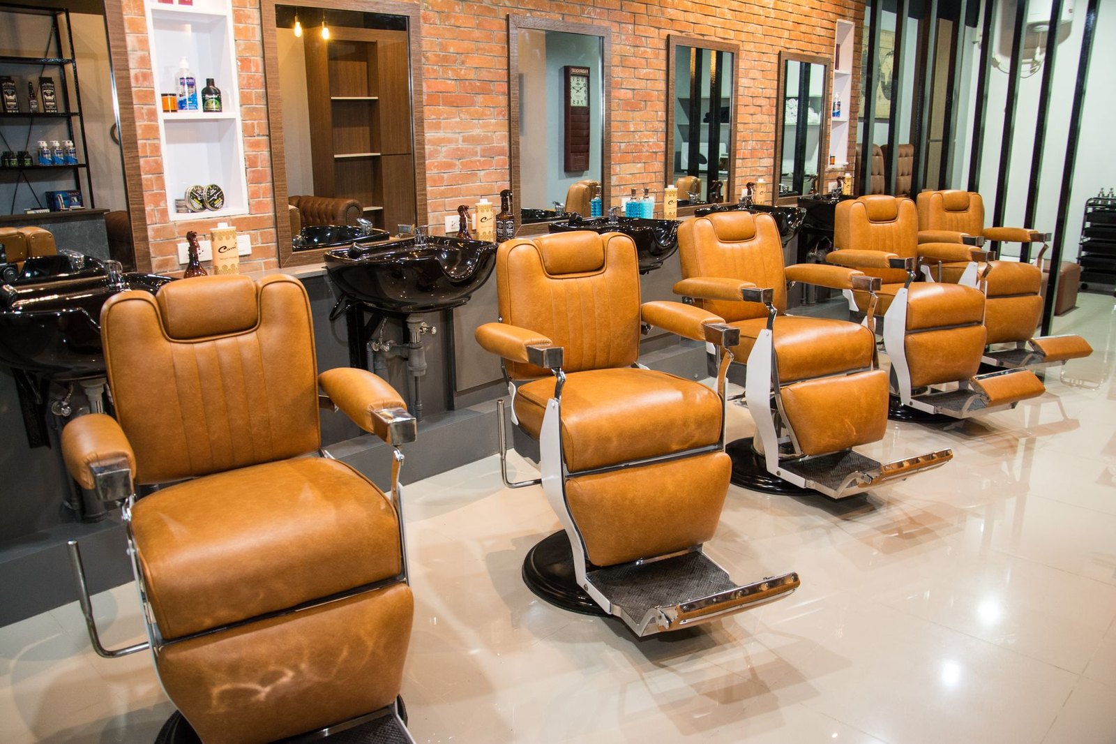 Interior of a men's grooming lounge with leather chairs and low lighting