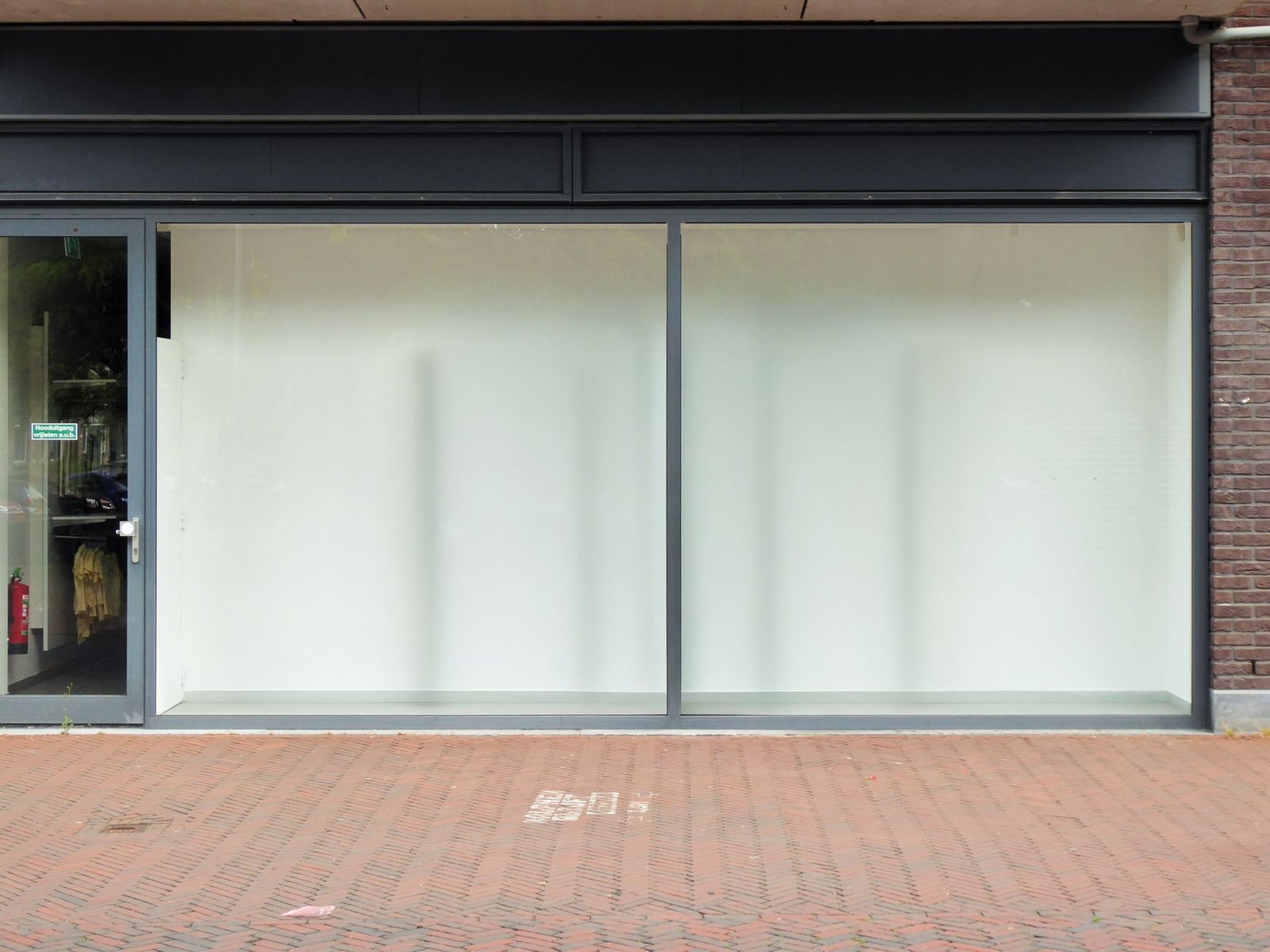 Empty retail storefronts in a newly built shopping center awaiting tenants