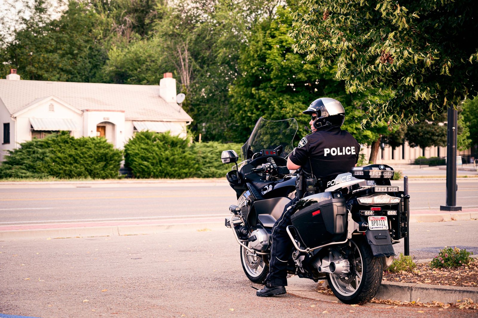 A police officer on a motorcycle at a busy intersection conducting traffic enforcement