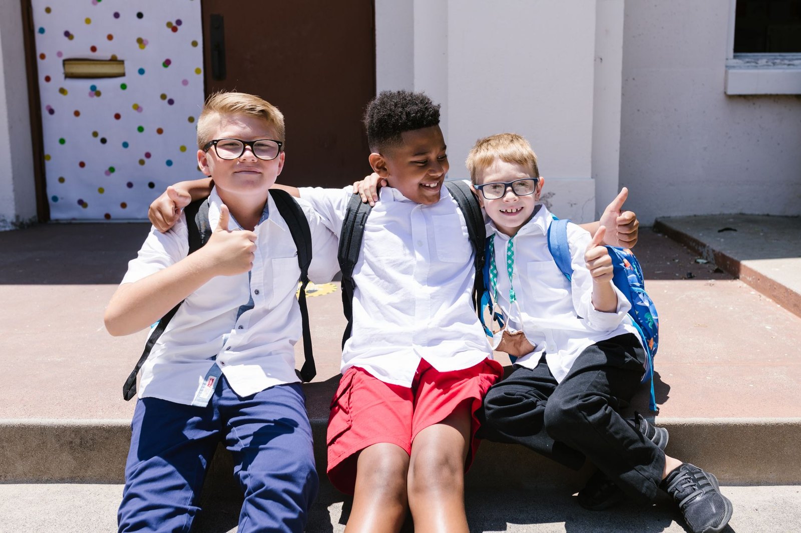 Students with backpacks arriving at school on the first day