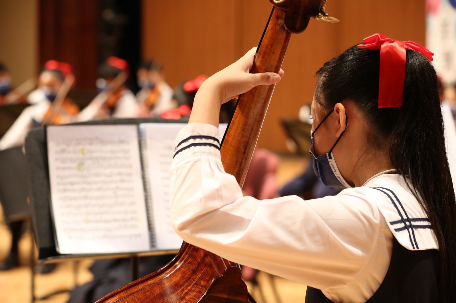Middle school students playing wind instruments in band concert