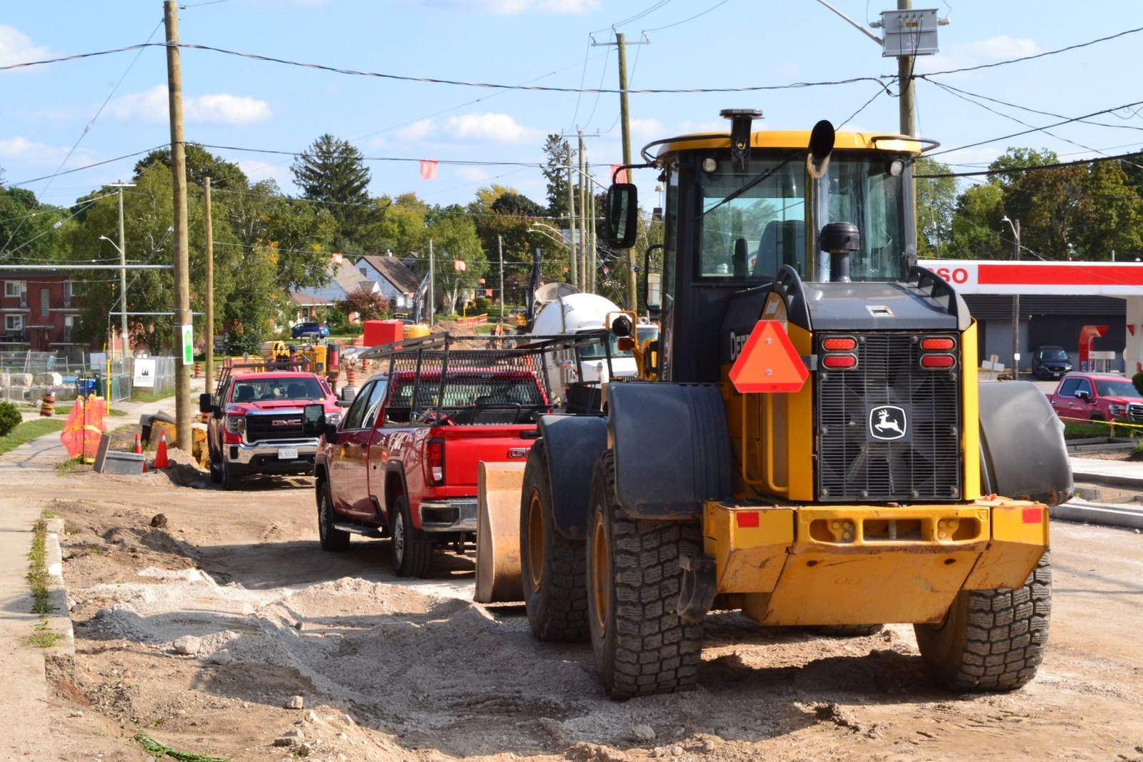 Construction crew replacing concrete roadway panels during a neighborhood street reconstruction project