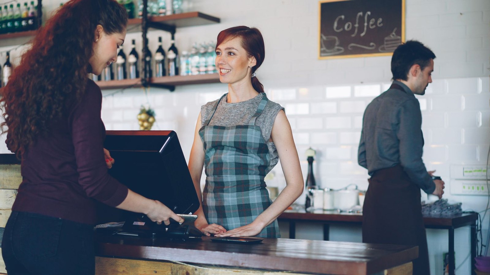 Barista preparing espresso drinks at an independent coffee shop counter
