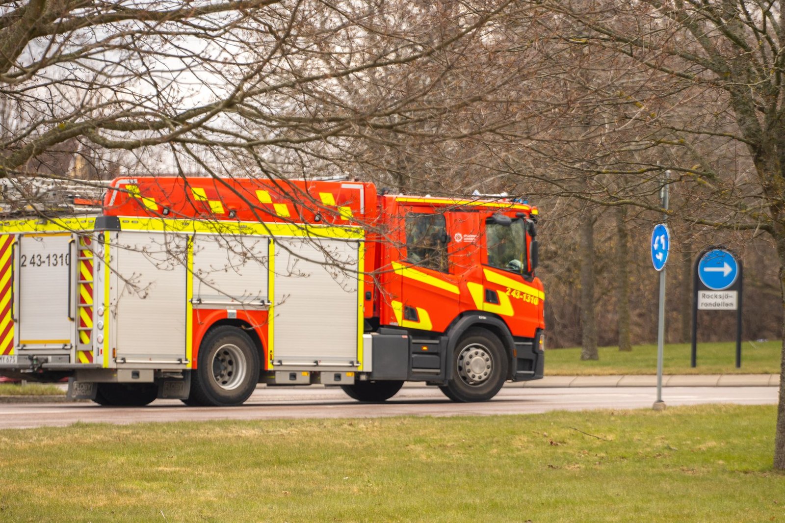 Fire engine driving through a suburban neighborhood on an emergency call