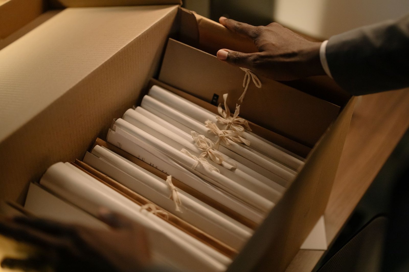 Cardboard boxes filled with paper documents lined up for secure shredding at a community event