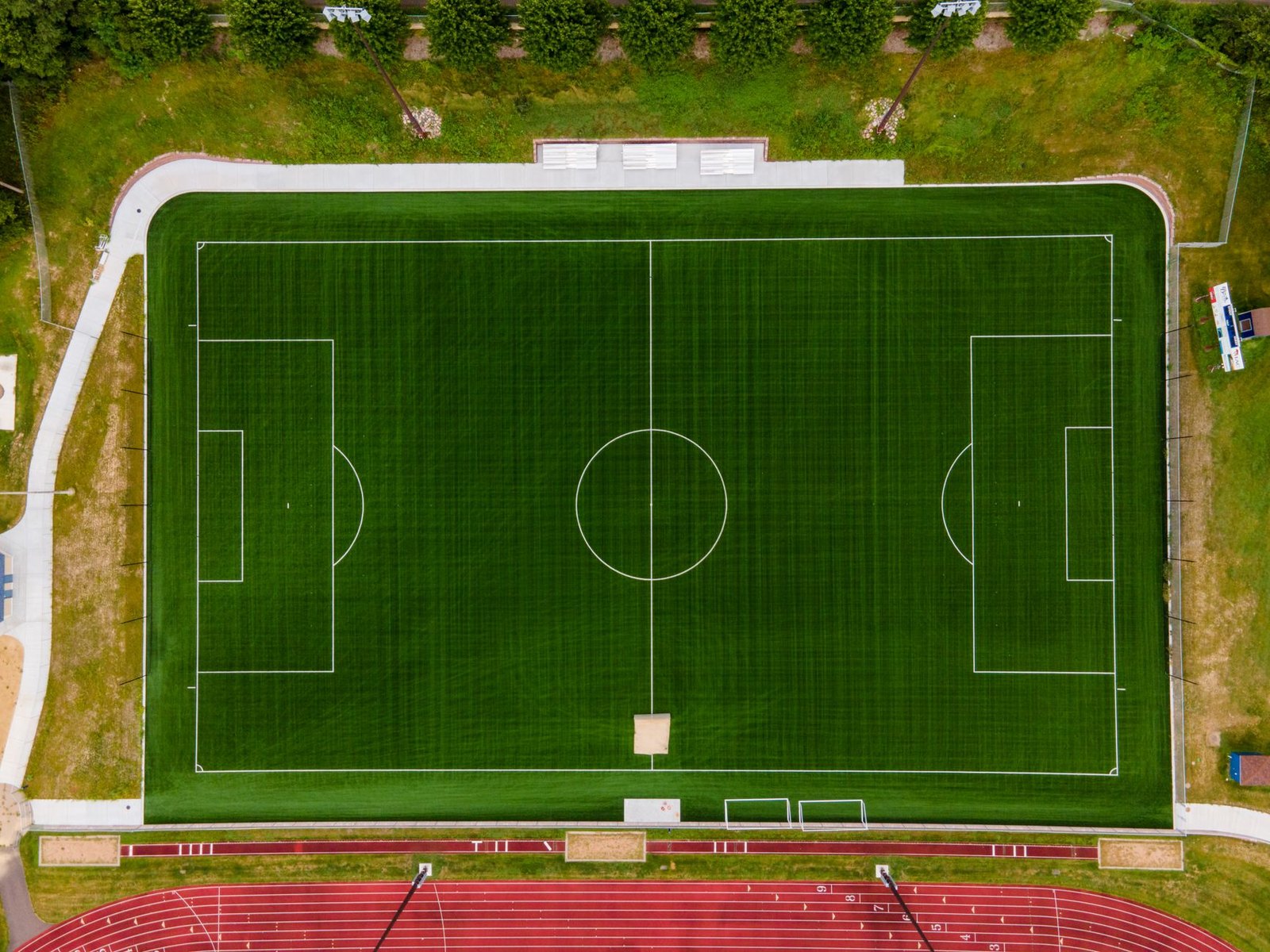 Workers installing synthetic turf on a soccer field at Chinn Chapel Soccer Complex in Flower Mound, TX