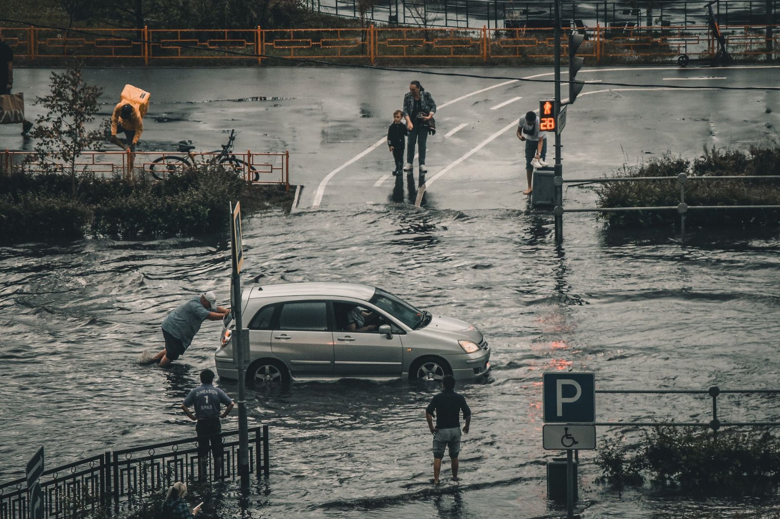 Flooded low-water crossing road with water rushing over pavement