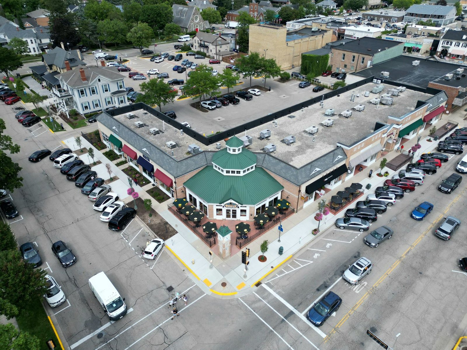 Suburban parking lot with landscaped tree islands and striped spaces in Flower Mound, TX