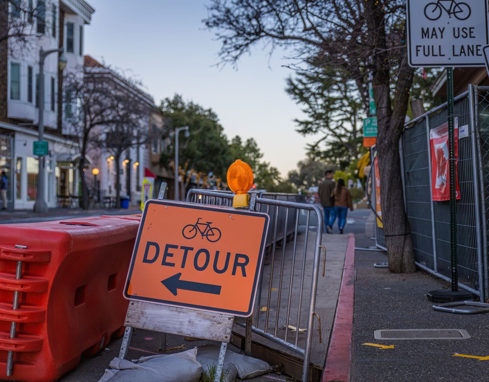 Orange construction warning barriers near a school zone