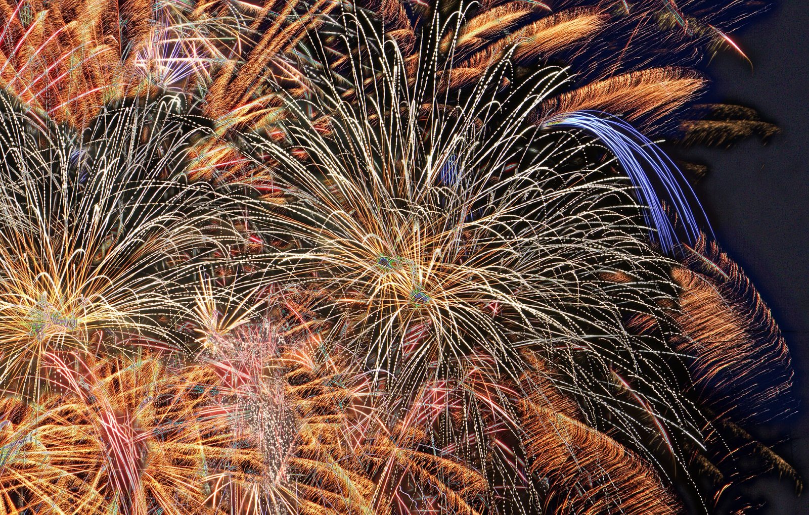 Fireworks exploding above Bakersfield Park during Flower Mound's Independence Fest