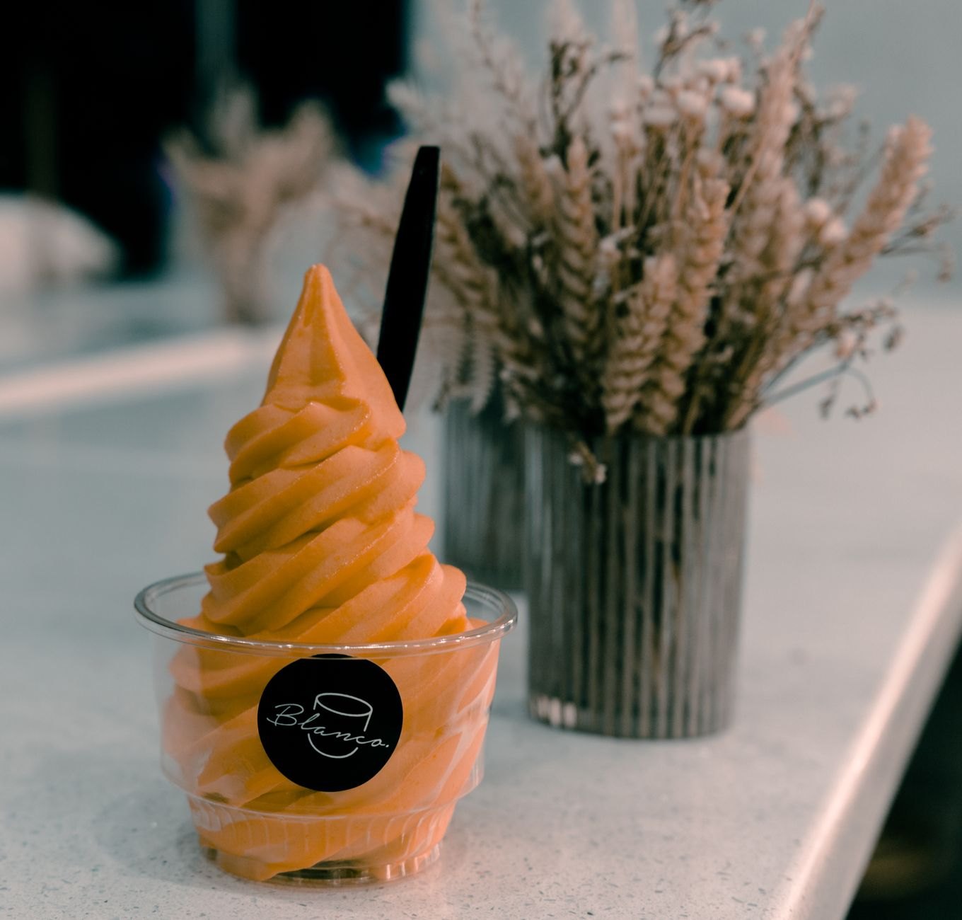 Layered Italian ice and soft serve ice cream in cup