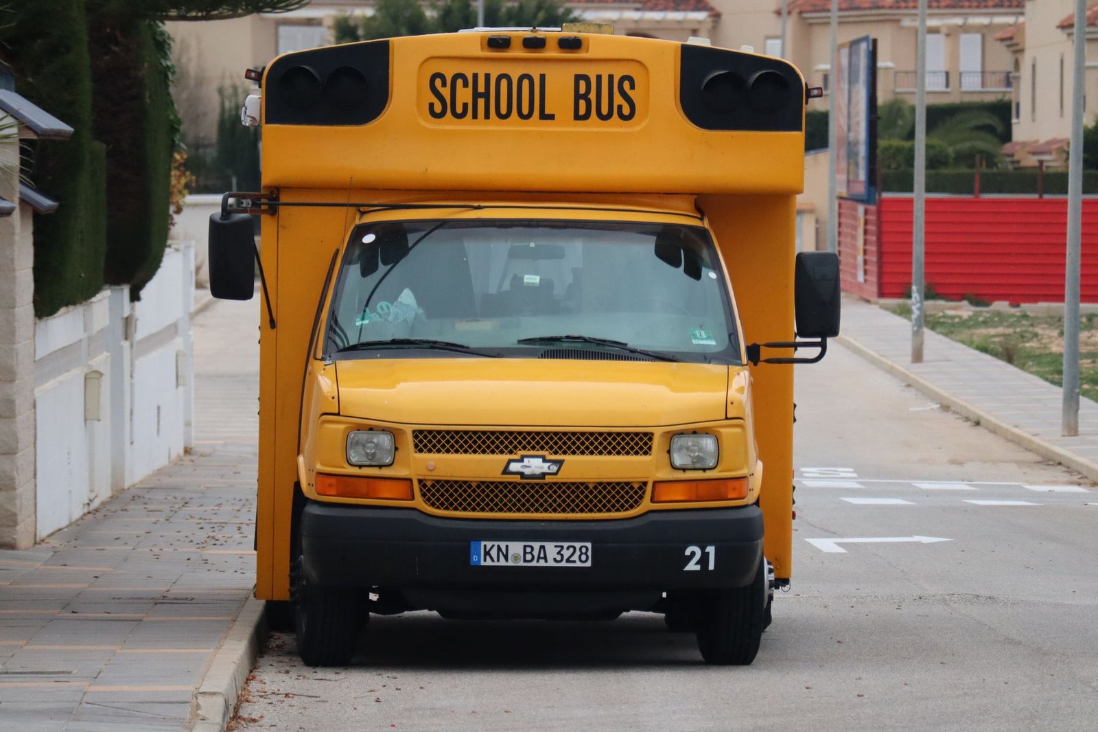 A yellow school bus parked at an LISD school drop-off zone in Lewisville, Texas