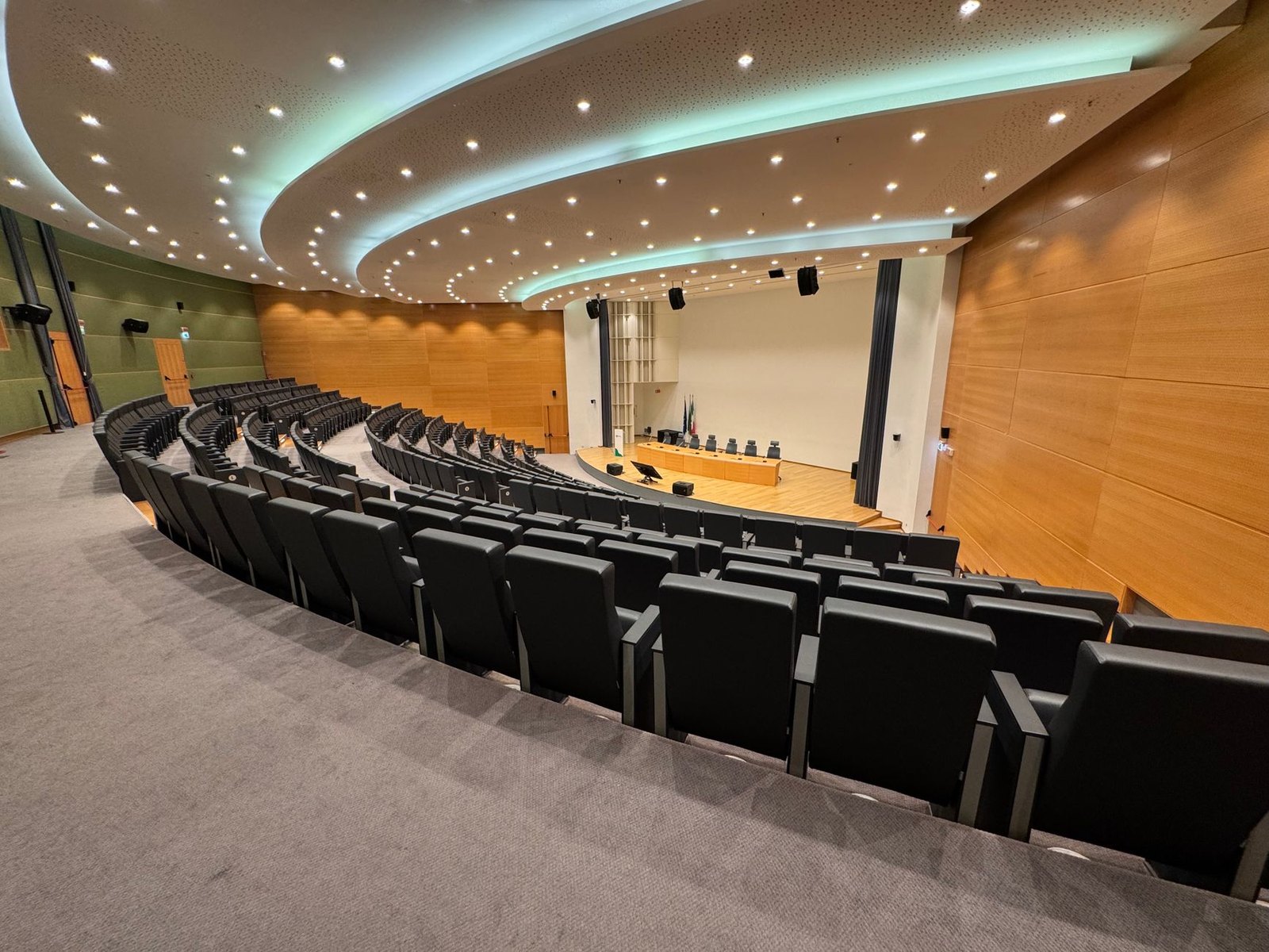 Empty school board meeting chamber with rows of seats before a public session
