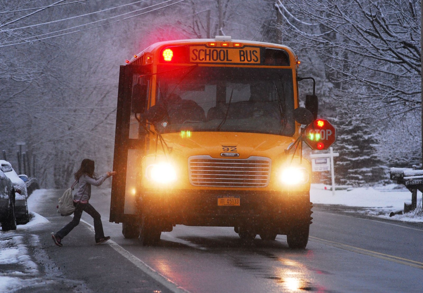 A school zone sign lit up during morning drop-off traffic