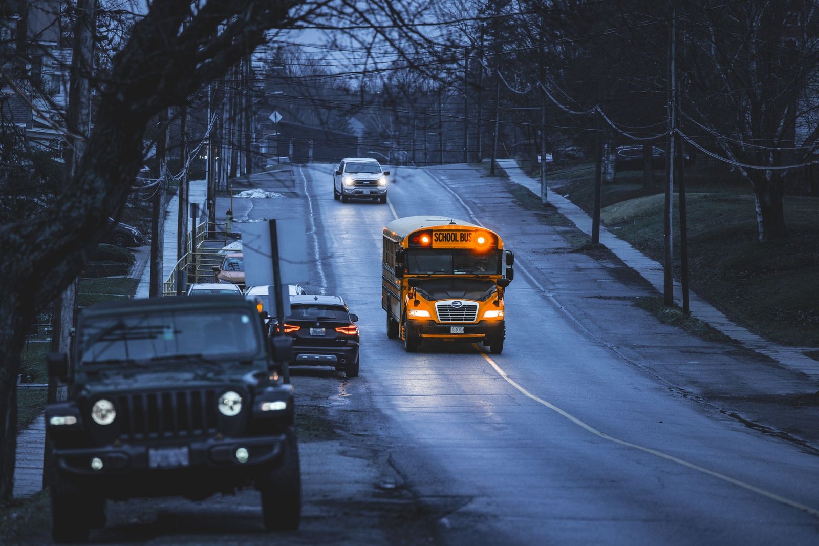 Yellow school bus stopped at a residential street curb during morning pickup