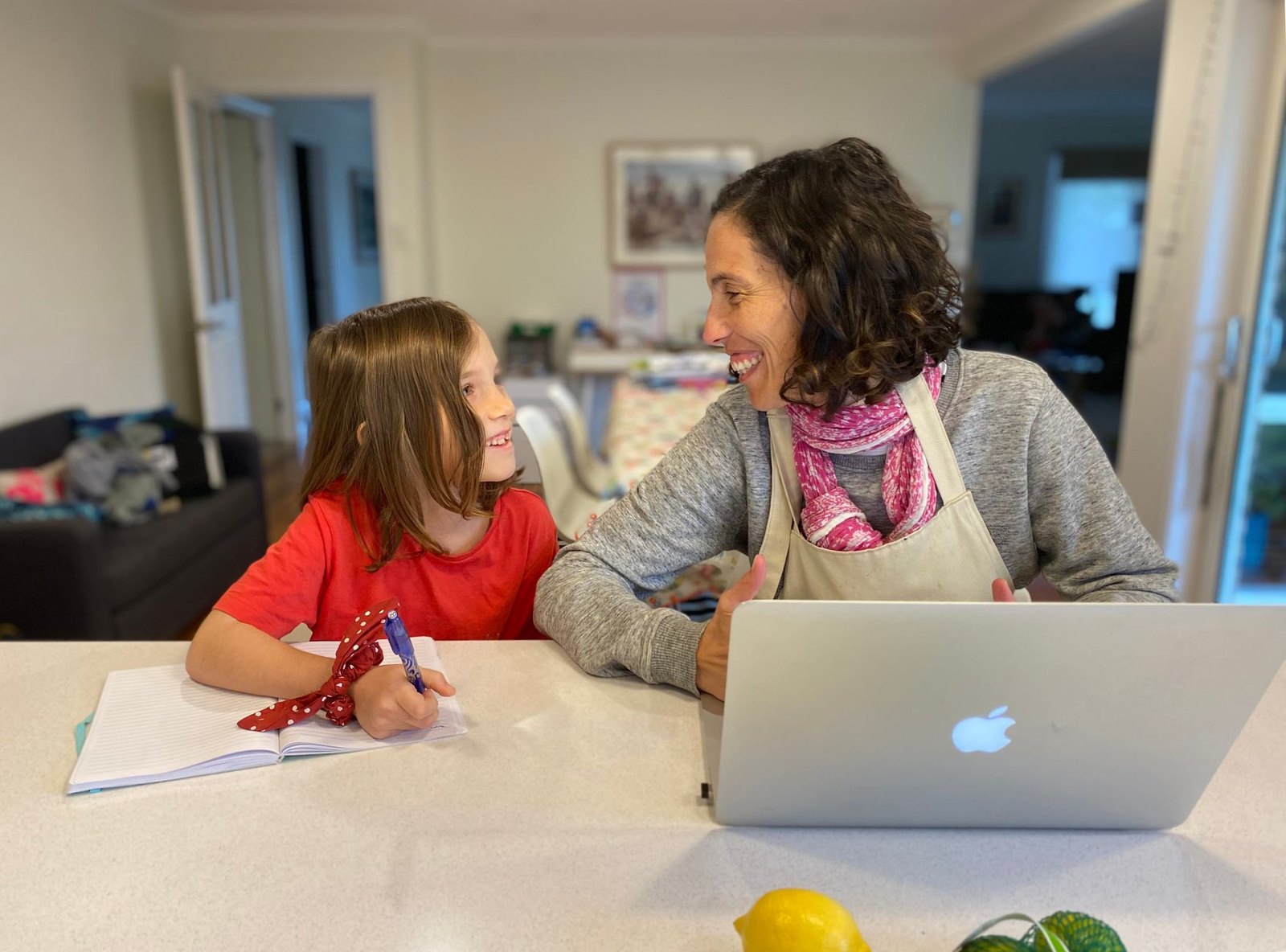 Parent helping child log into a school information portal on a laptop