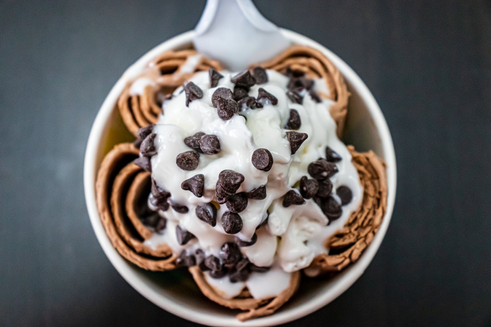 Hand-rolled ice cream rolls arranged in a cup with toppings
