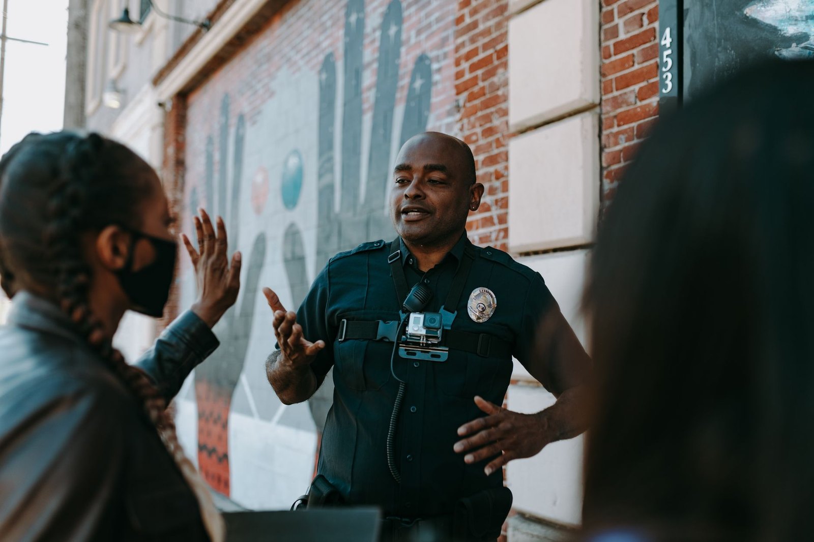 Police officer talking with residents at neighborhood event