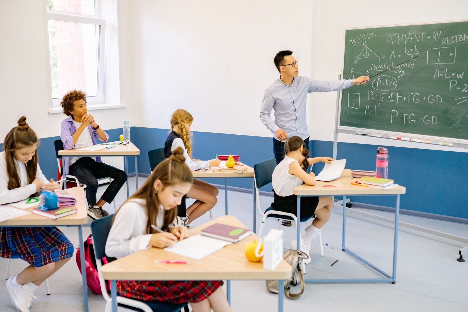 Elementary school students working on math problems at desks