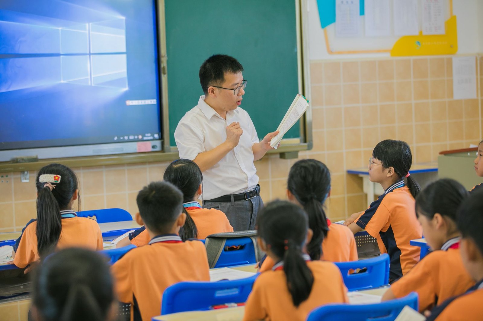 Teacher reading aloud to middle school students classroom