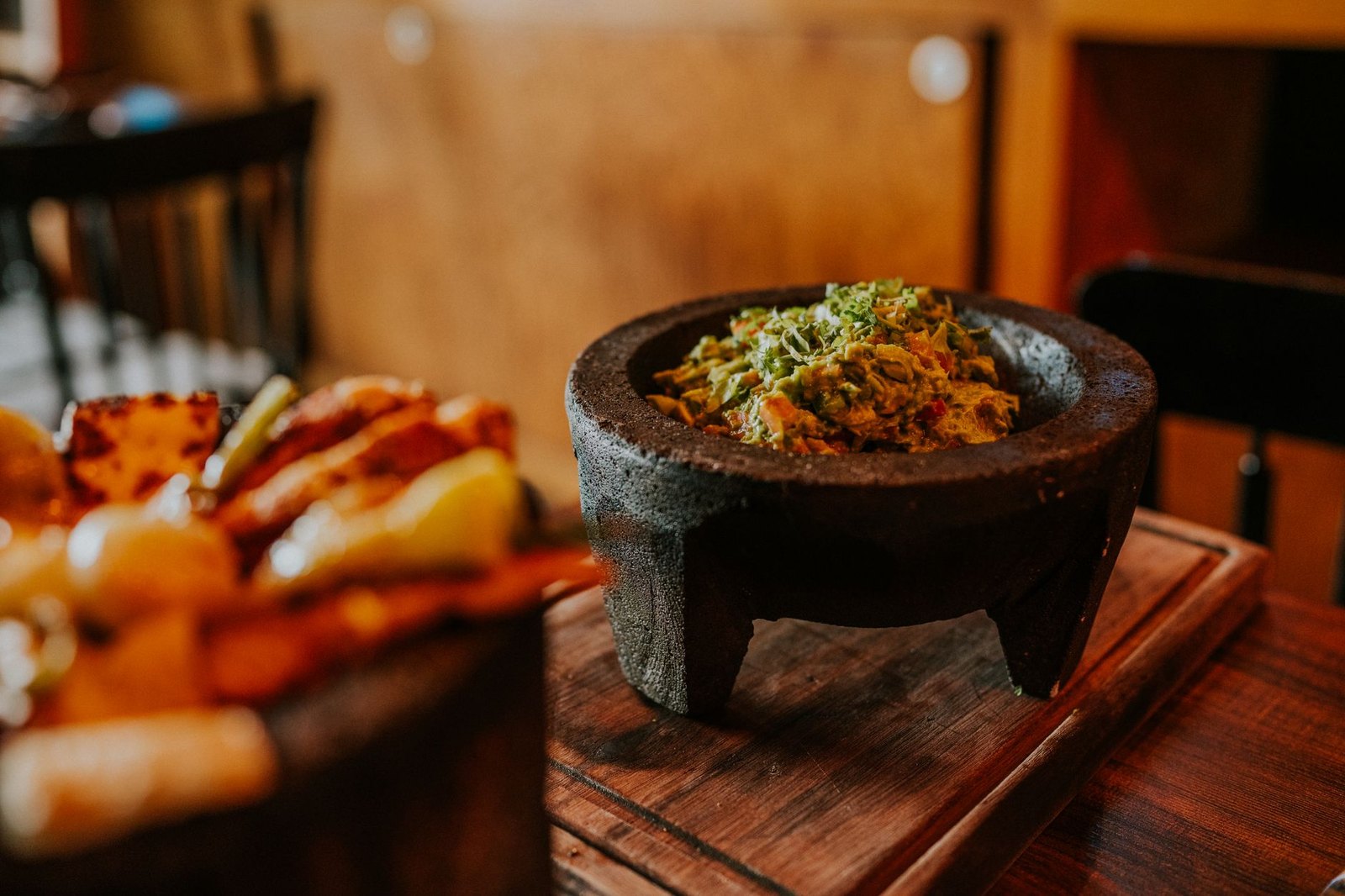 Fresh guacamole being prepared table-side at a Tex-Mex restaurant