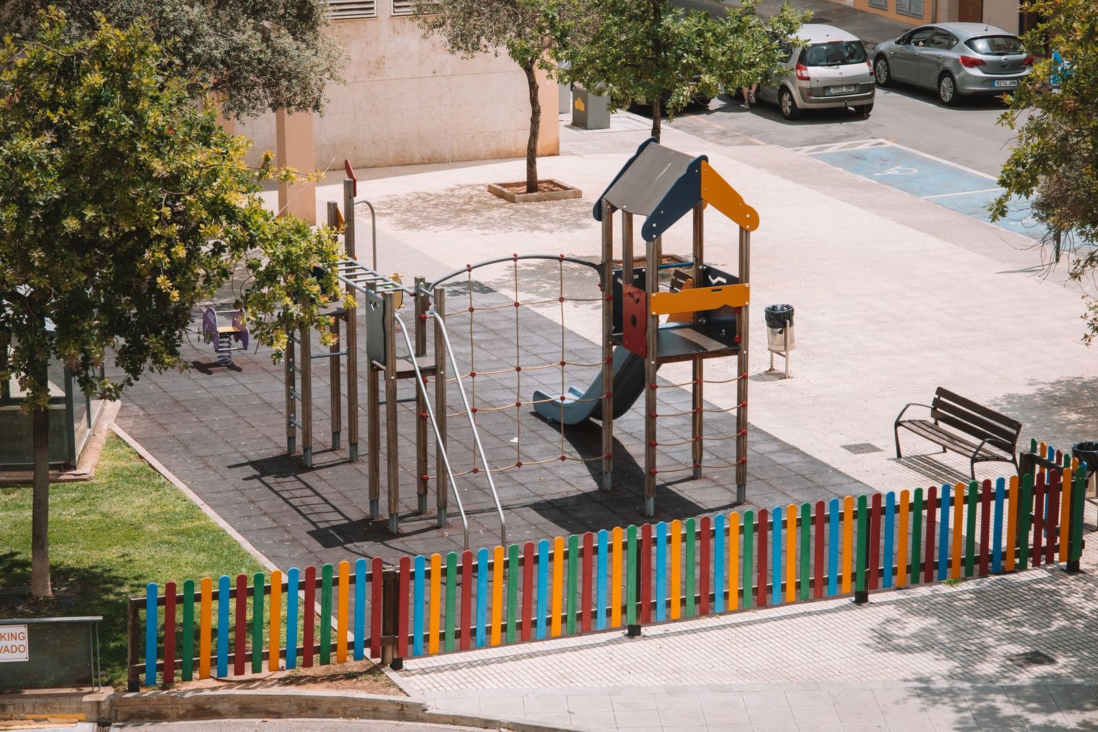 Construction fencing around a park playground area during renovation