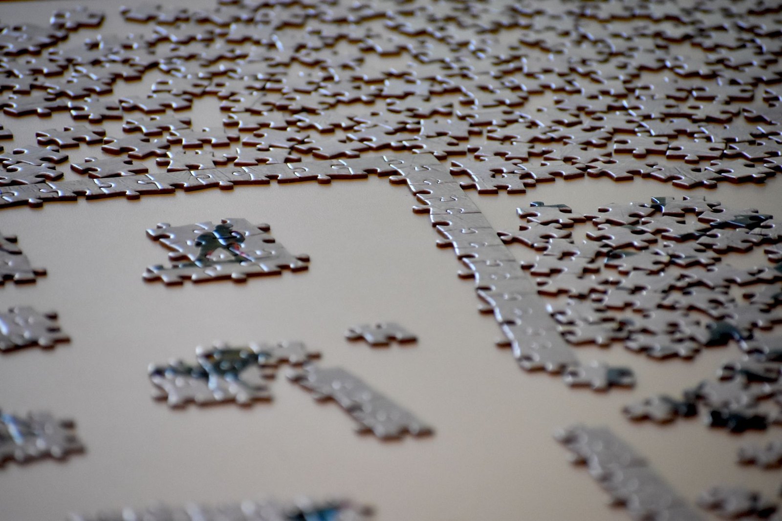 Jigsaw puzzle pieces spread on table