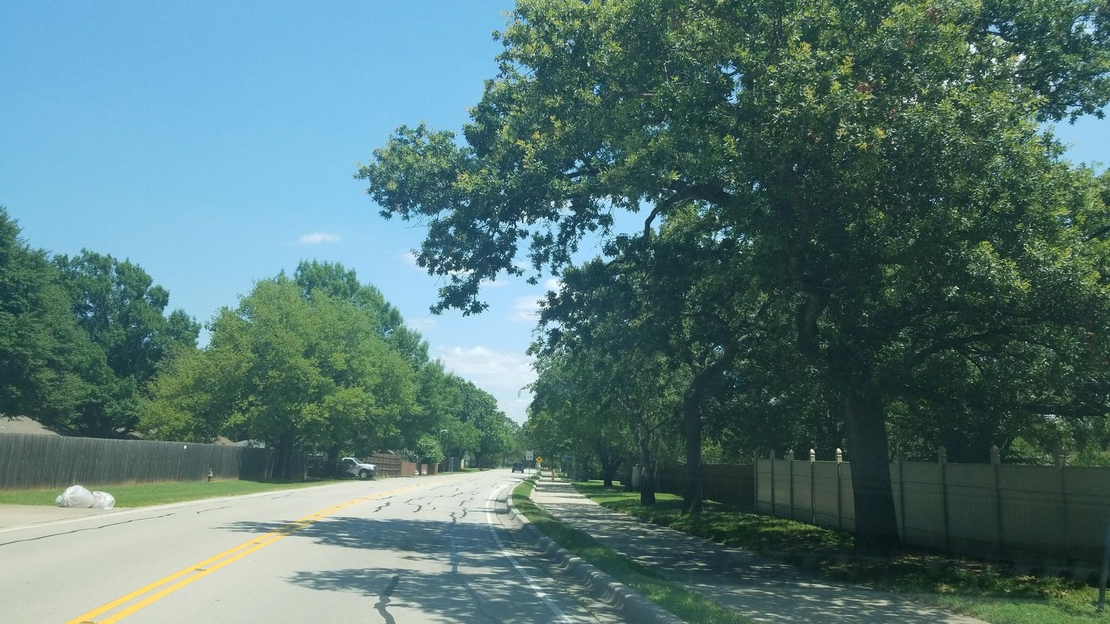 Asphalt paving work on a residential street in Highland Village