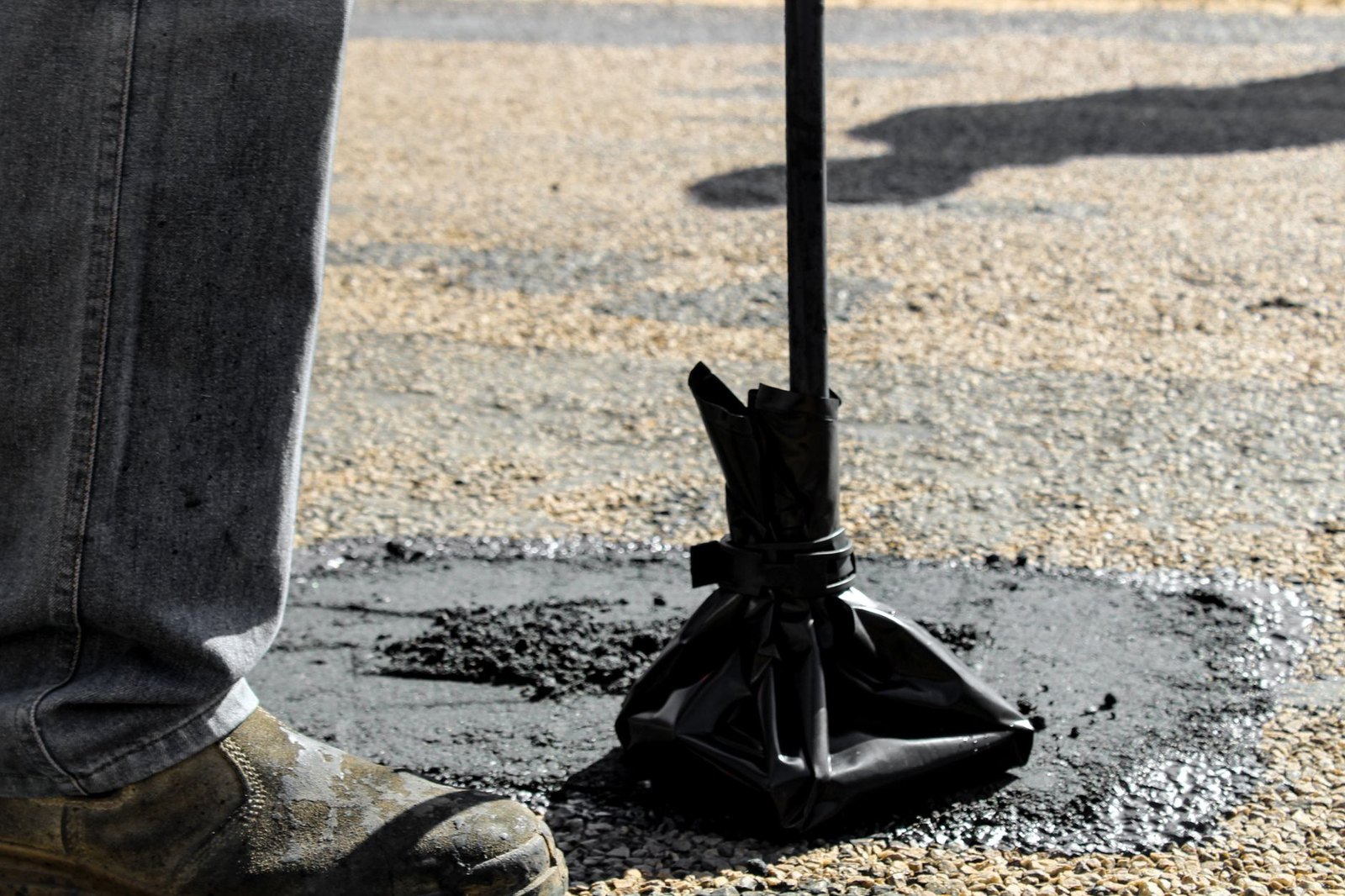 Street maintenance road repair crew patching pavement