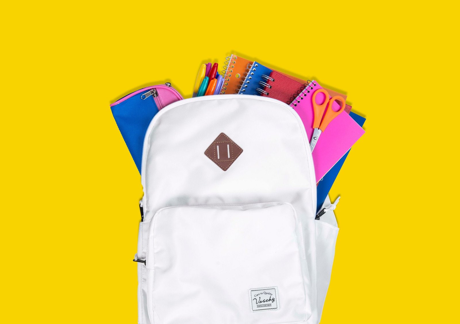 Shopping cart filled with back-to-school supplies including a backpack, notebooks, and pencils