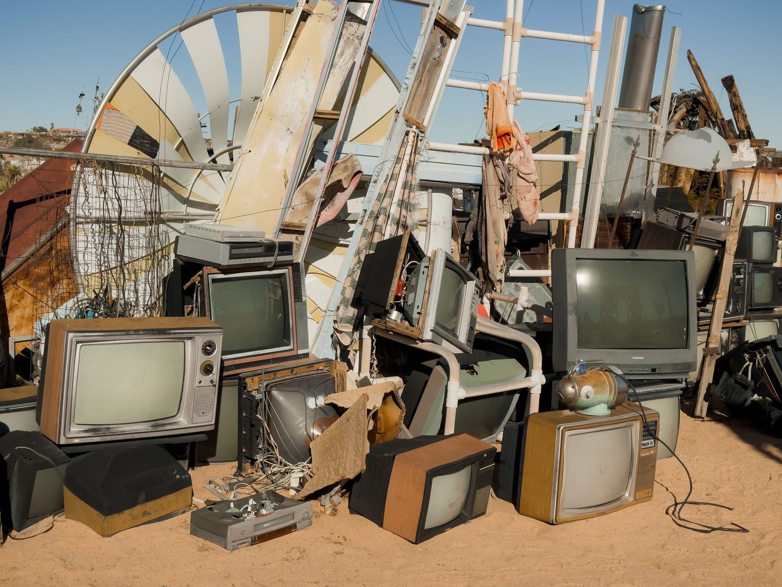 Pile of old electronics laptops phones monitors ready for recycling