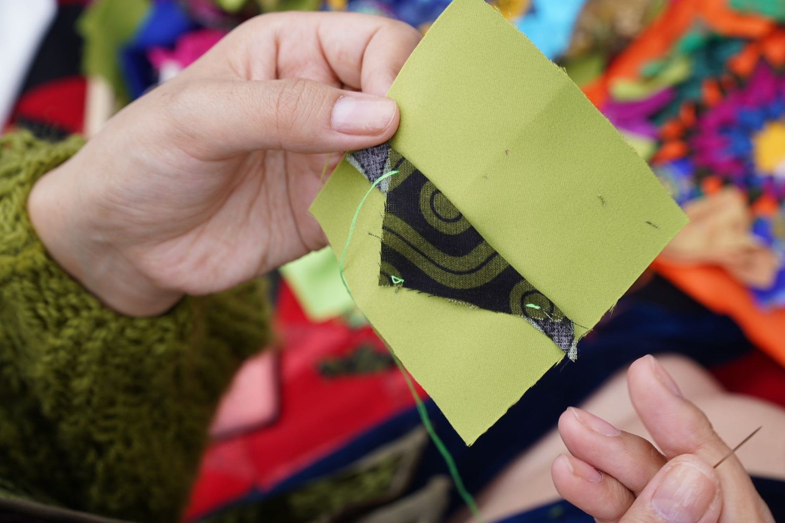 Close-up of colorful batik fabric pieces sewn together in an intricate quilt pattern