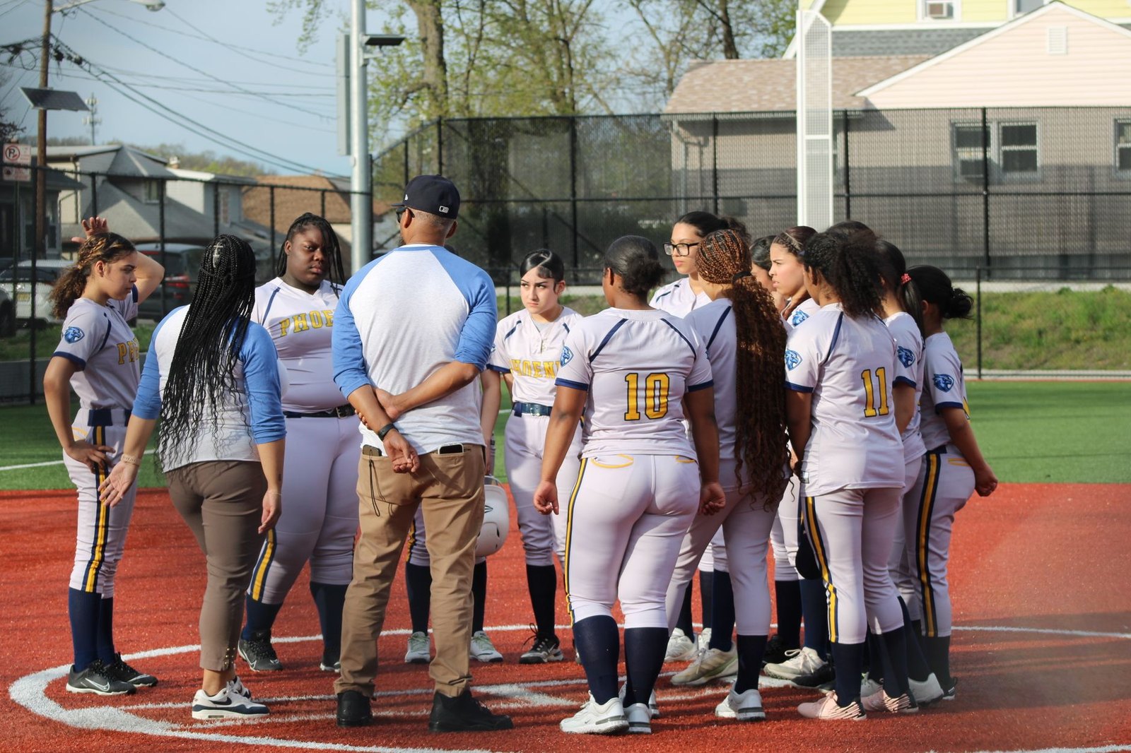 Flower Mound Jaguars girls softball players on the field after a playoff win