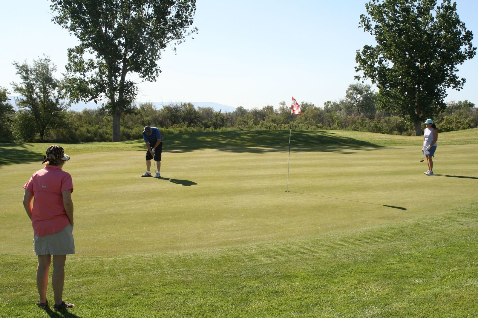 High school girls golf team practicing on a course green