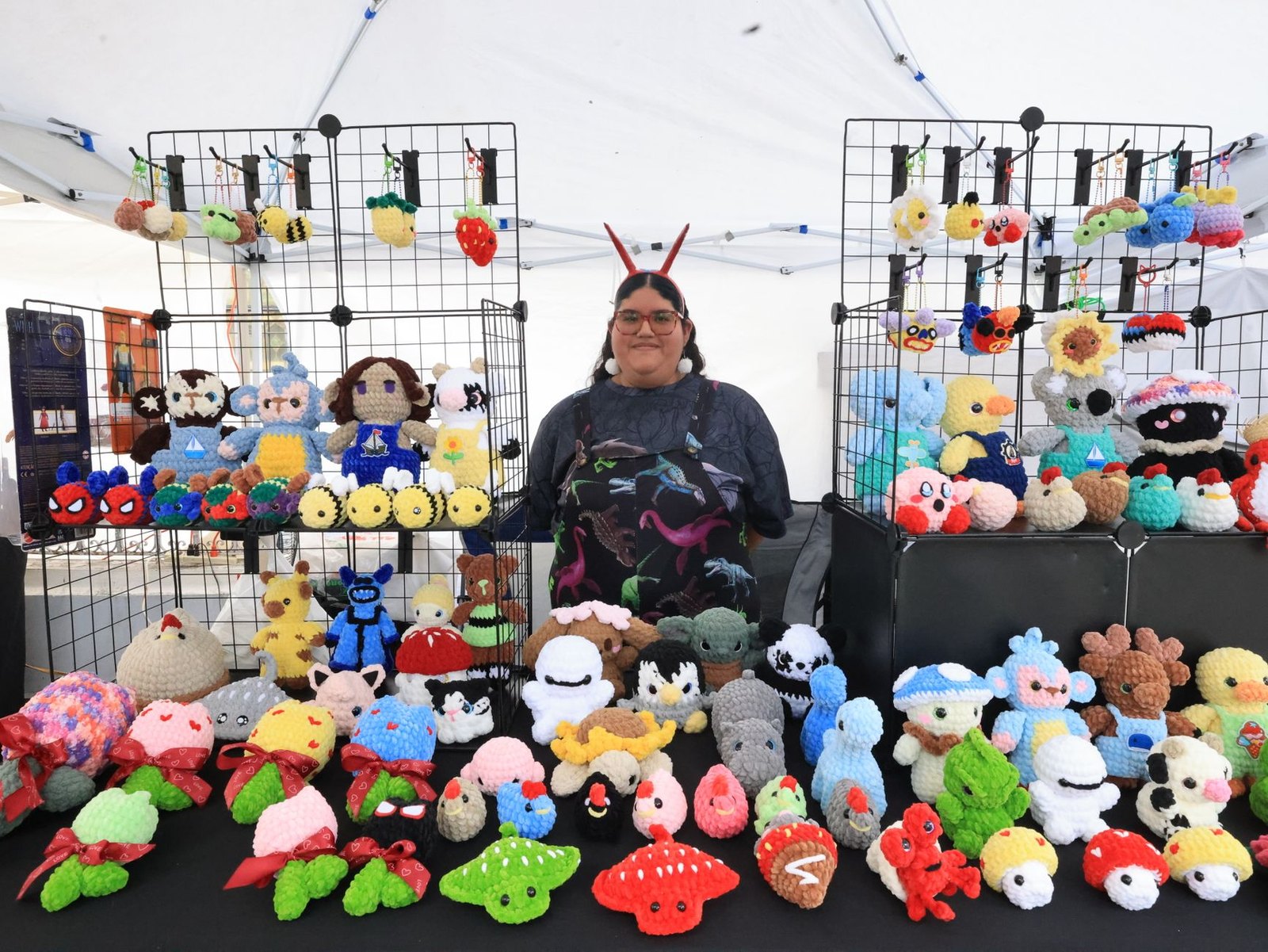 Indoor craft fair vendor tables with handmade jewelry and home décor on display