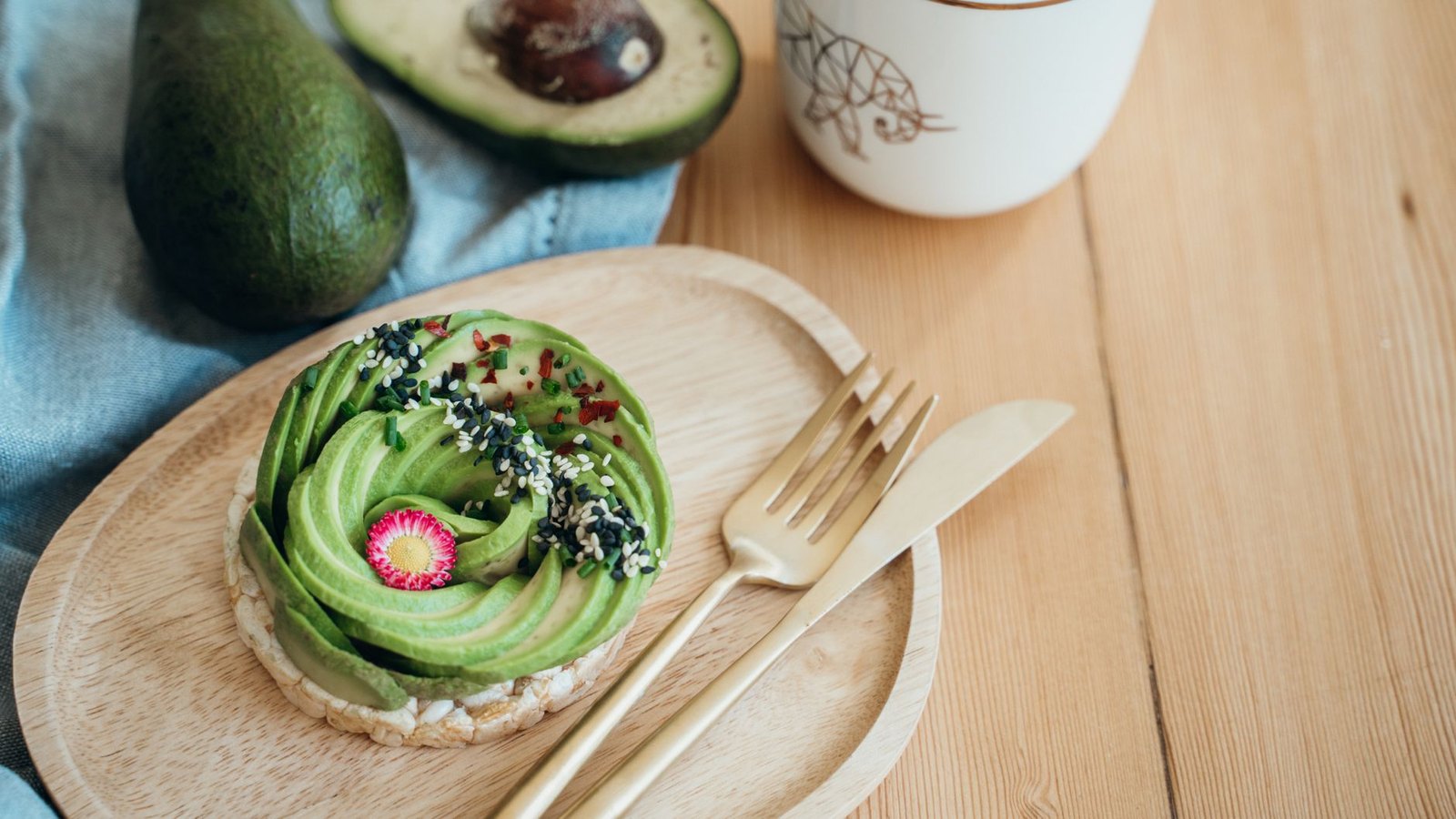 Gourmet avocado toast with microgreens and radish on wooden board