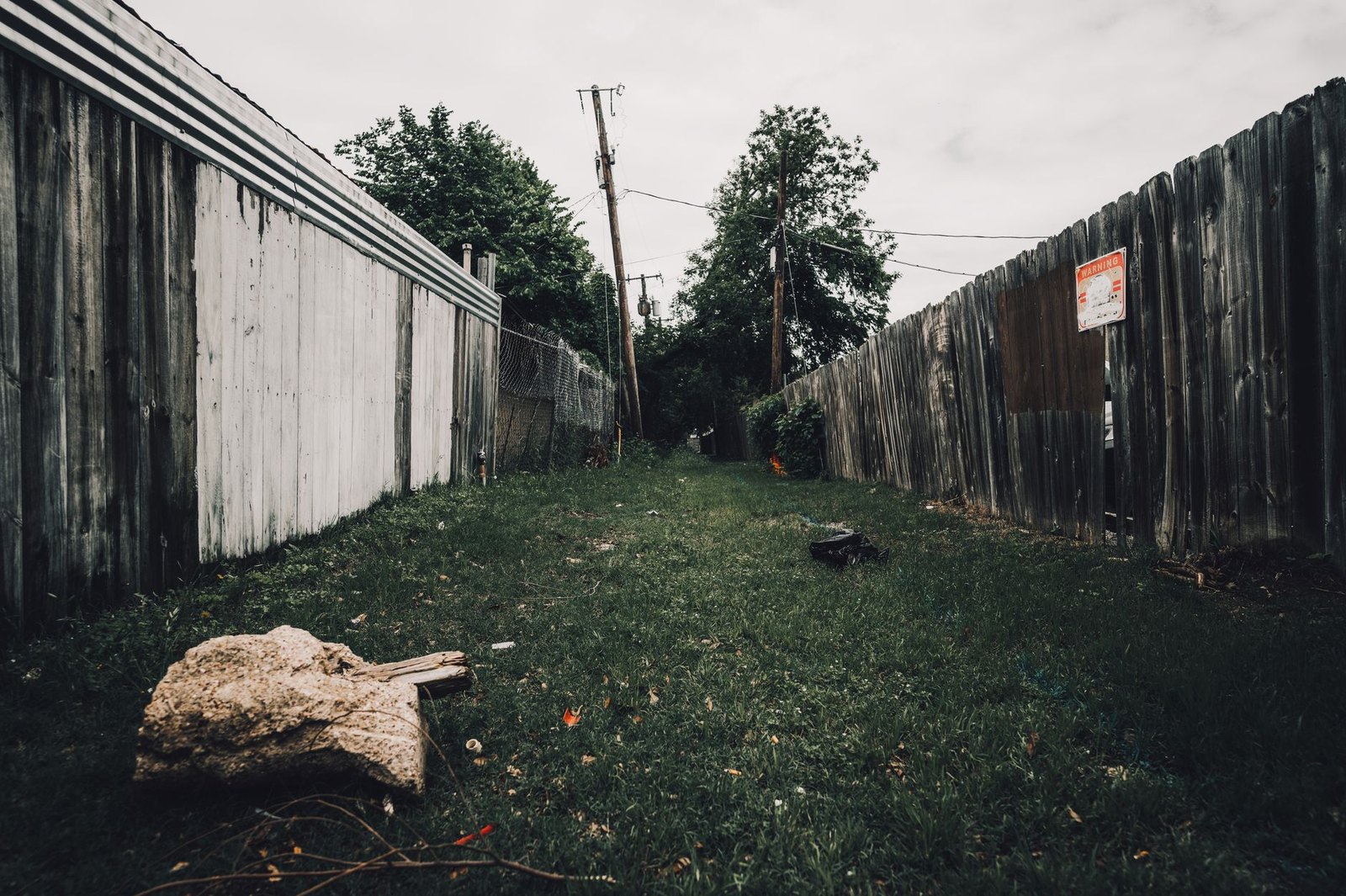 Gas pipeline easement corridor through residential neighborhood with mature trees