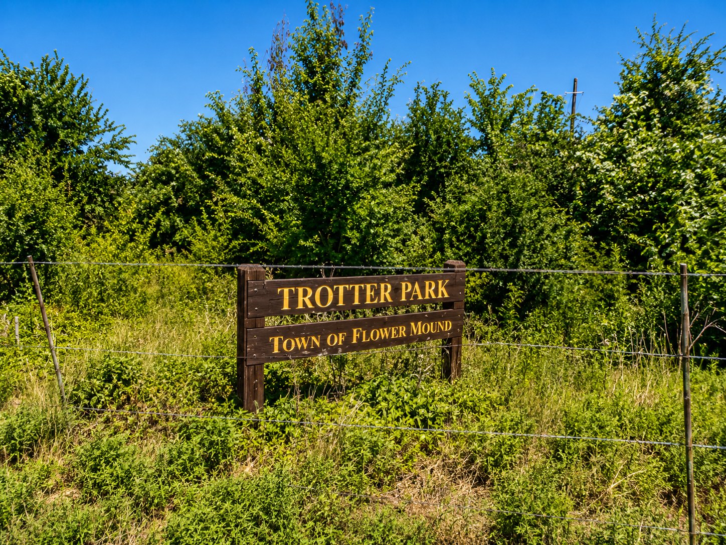 Empty grassy parcel at 4551 Cross Timbers Road where Trotter Park construction begins September 7