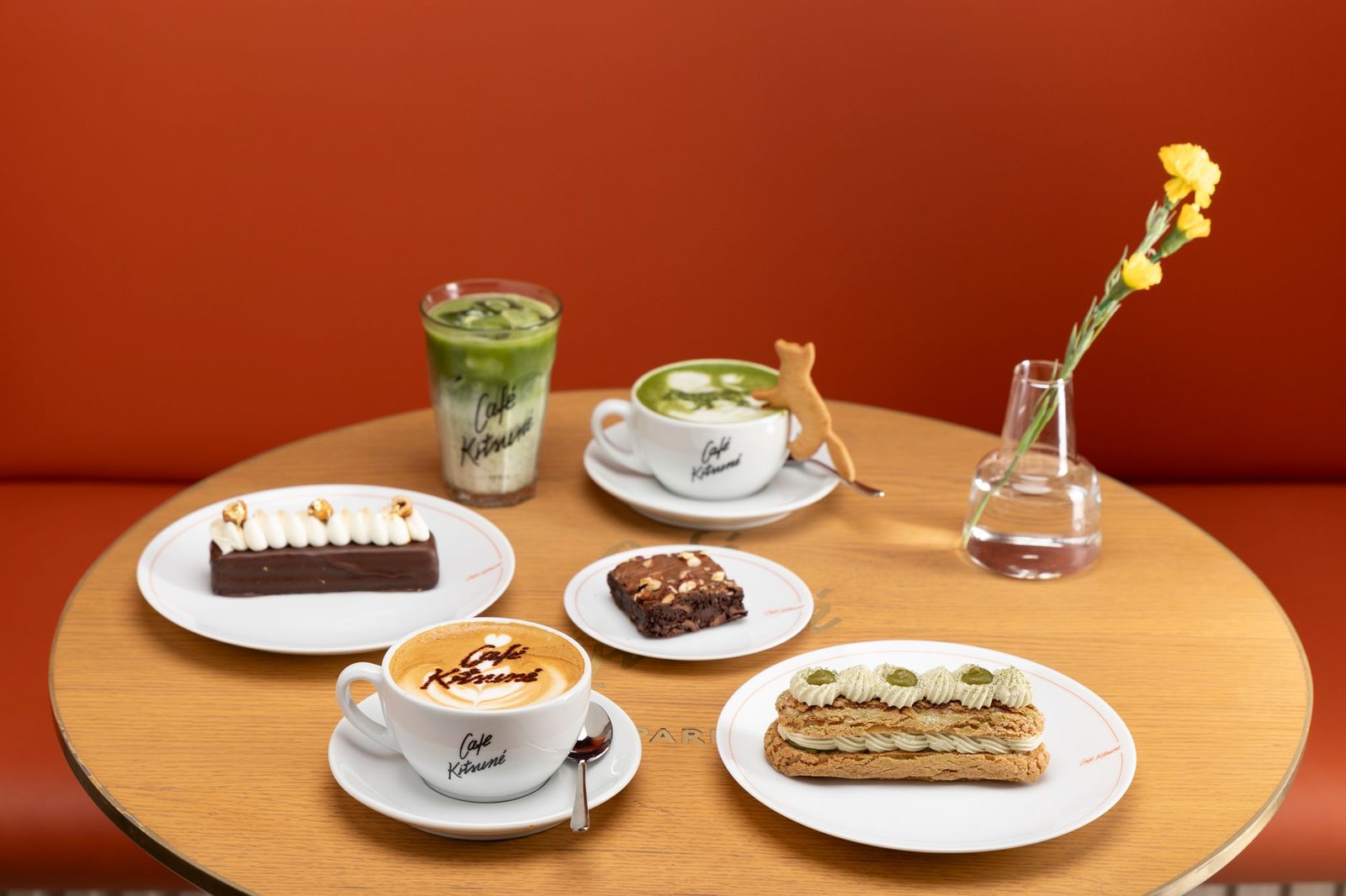 Specialty coffee drinks and baked goods on a café counter