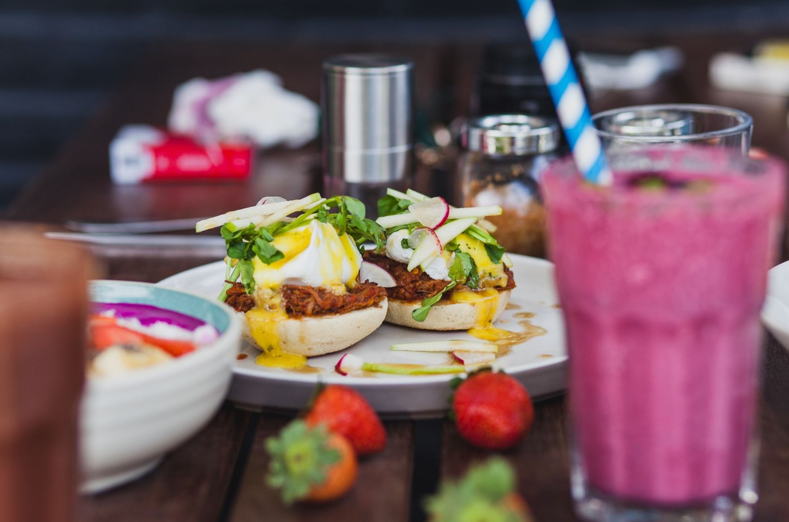 Brunch plate with eggs benedict and specialty coffee, style of Wildflower Café