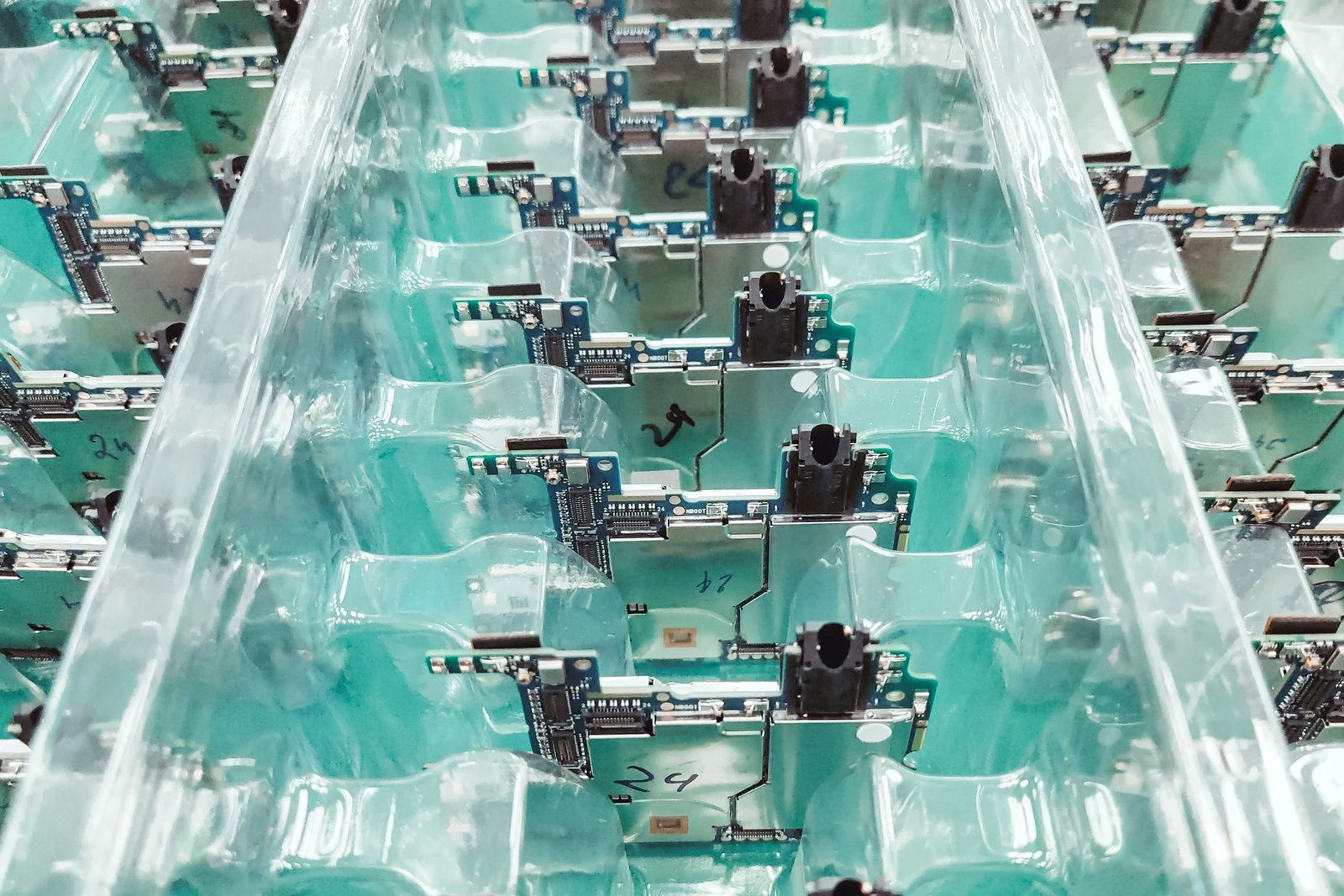 Electronics manufacturing floor with server components and circuit boards, representing Wistron's AI supercomputing production